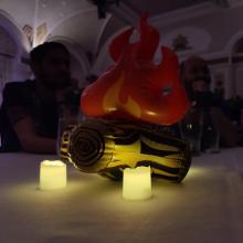 People singing around an inflatable campfire