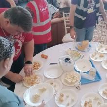 People tasting various cheeses