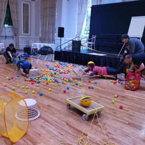 People playing live action Hungry Hippos