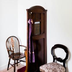 Two chairs, one either side of a confessional screen.
